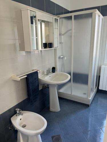 a bathroom with a sink and a toilet and a shower at Apartment Bencic in Fažana