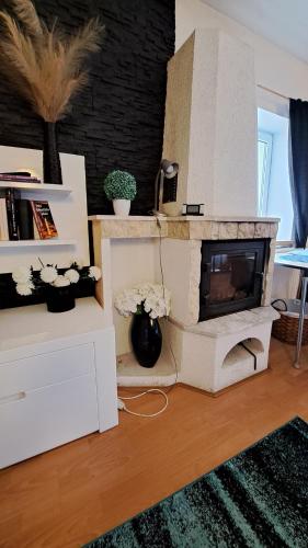 a living room with a white fireplace in a living room at Pension Jana Tatrovice in Tatrovice