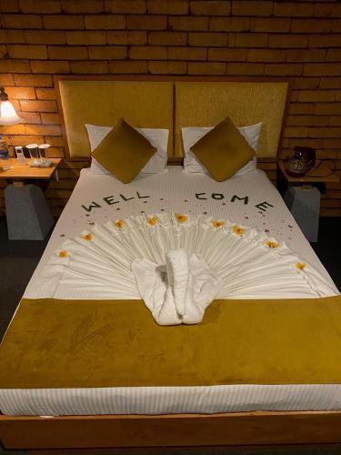 a bed with white socks and flowers on it at Elephant Arcade in Tissamaharama