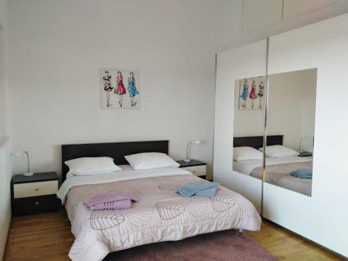 a bedroom with a bed and a mirror at Apartment Mia - Spacious apartment on 85 m2 with beautiful sea view in Trogir