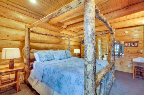 a bedroom with a bed in a log cabin at Smoky Mountain Vacation Rental with Hot Tub! in Gatlinburg