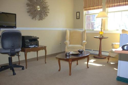a living room with a chair and a television at Garden South Park Inn in Halifax