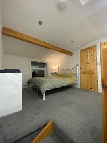 a bedroom with a bed in a room at Park View Cottage in Liversedge