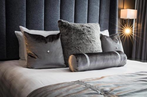 a bedroom with a bed with pillows at Wolfscastle Country Hotel in Treffgarne