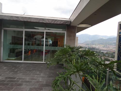 a view of a building with mountains in the background at Hotel bh El Poblado in Medellín