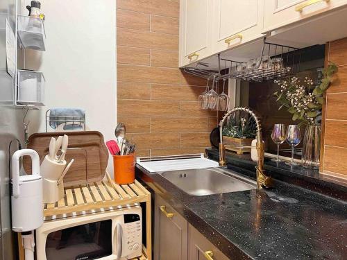 a kitchen with a sink and a microwave at Urban Garden French in Seoul