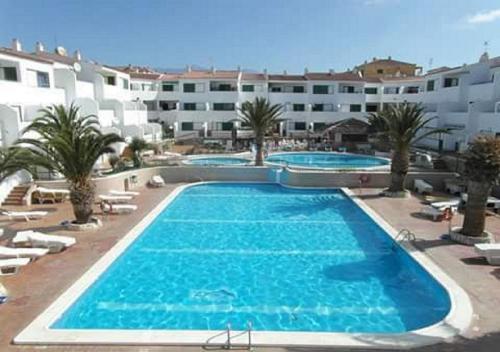 a large swimming pool in front of a building at Antomax Apartment in Costa del Silencio - WI FI in Costa Del Silencio