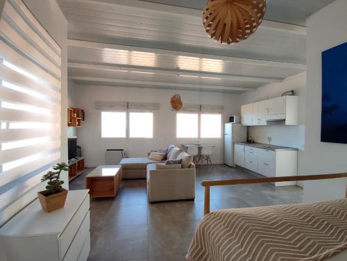 a bedroom with a bed and a living room at Ático en Las Canteras in Las Palmas de Gran Canaria