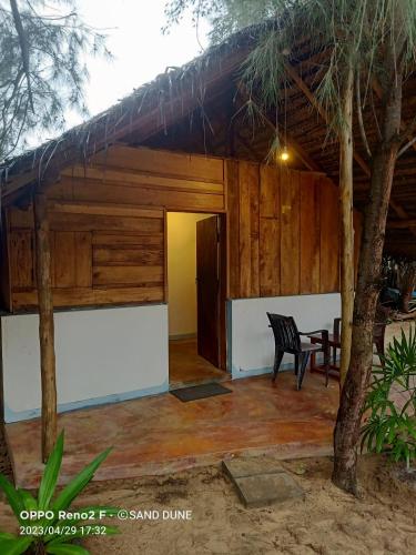 a view of the outside of a house with a table at Sand Dune Beach Resort & Surf Camp in Arugam Bay