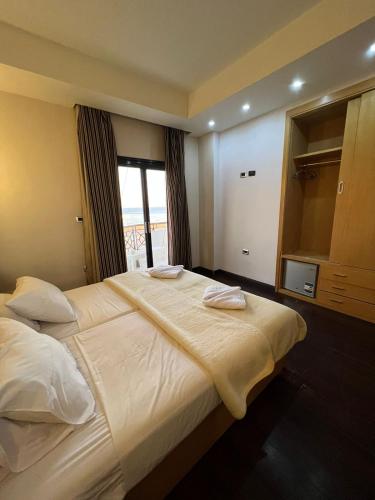 a large bed in a room with a large window at sea view house in Marsa Alam City