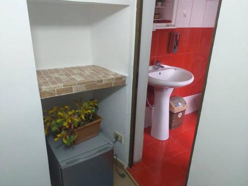 a small bathroom with a sink and a toilet at Kulla e Vjeter (Bar Restaurant, Guesthouse, Parking and Camping) in Koman