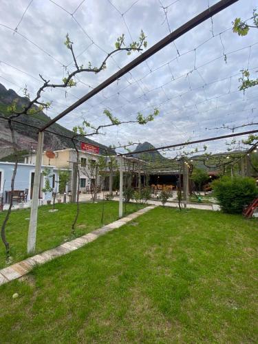a park with a fence in the grass at Kulla e Vjeter (Bar Restaurant, Guesthouse, Parking and Camping) in Koman