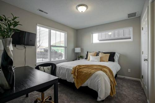 - une chambre avec un lit, un bureau et une fenêtre dans l'établissement Glam & Silver Home near Convention Ctr, à Indianapolis