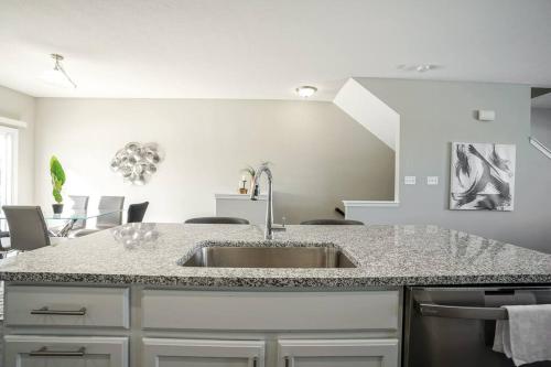 a kitchen with a sink and a counter top at Glam & Silver Home near Convention Ctr in Indianapolis