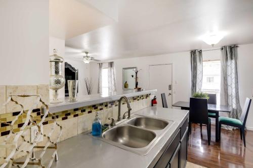 cocina blanca con fregadero y mesa en Chic Dallas Vacation Rental Pool, Walk to Knox St en Dallas