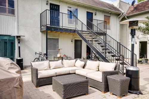 a couch sitting on a patio in front of a house at Chic Dallas Condo with Pool, Walk to Knox Street! in Dallas