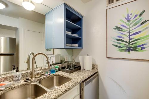 a kitchen with a sink and a mirror at Stylish Condo with Pool in Knox Henderson! in Dallas