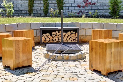 a fire pit with two logs in a yard at Roubenka pod Troskami in Ktová