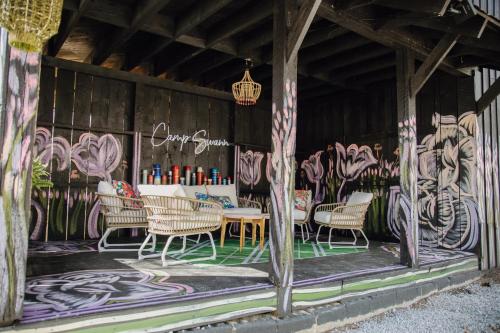 a table and chairs in a room with graffiti at Camp Swann in Tracy City