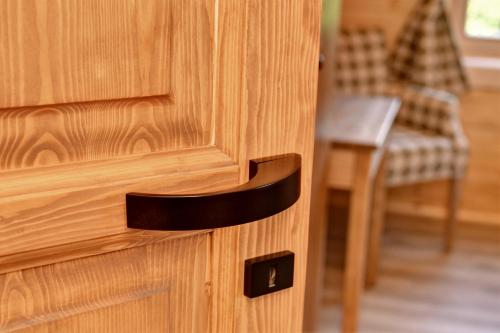 a close up of a wooden door with a handle at Roubenka pod Troskami in Ktová