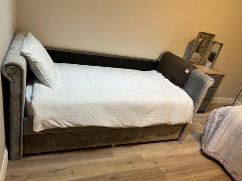 a bed in the corner of a room at Knockreagh Farm Cottages Mountain or Cedar views in Kilkenny