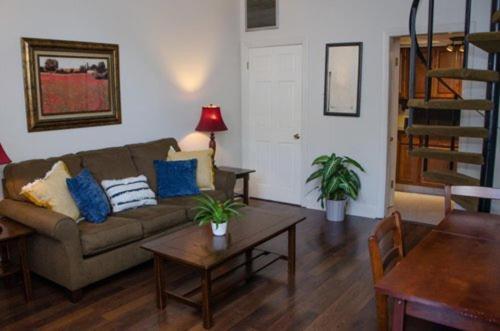 a living room with a couch and a table at Jean Lafitte House in New Orleans