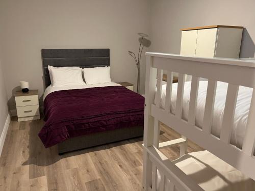 a small bedroom with a bed and a staircase at Knockreagh Farm Cottages Mountain or Cedar views in Kilkenny