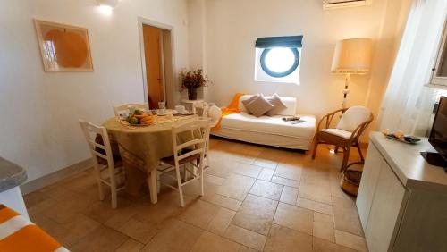 a living room with a table and a couch at Tenuta alla Castellana in Gallipoli