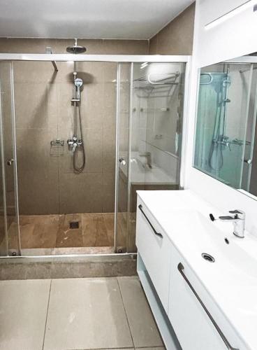 a bathroom with a shower and a sink and a shower at Studio G712 Blaxy in Olimp
