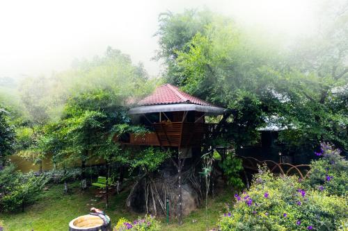 a tree house in the middle of a garden at Rock Hut Tabor Hills Resort Vagamon in Vagamon