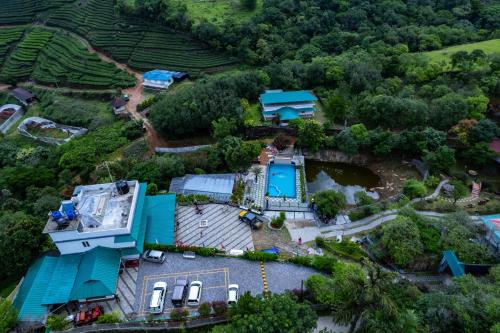 an aerial view of a house with a swimming pool at Rock Hut Tabor Hills Resort Vagamon in Vagamon