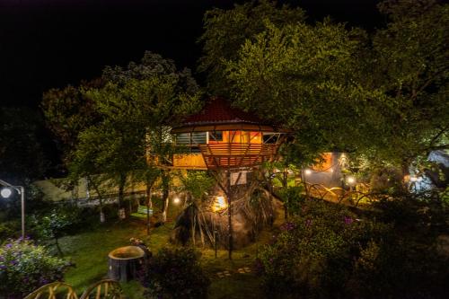 a tree house in a park at night at Rock Hut Tabor Hills Resort Vagamon in Vagamon