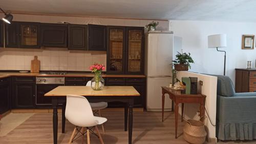 a kitchen with a table with a vase of flowers on it at Pia's Home in pieno centro storico in Palermo