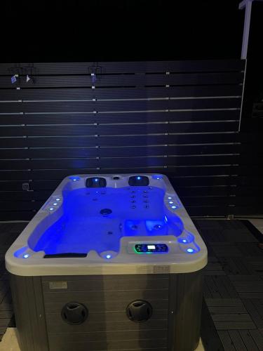 a jacuzzi tub with blue lighting in a room at Loft Spa Greece - Enjoy our Jacuzzi & Hammam in Kalamata