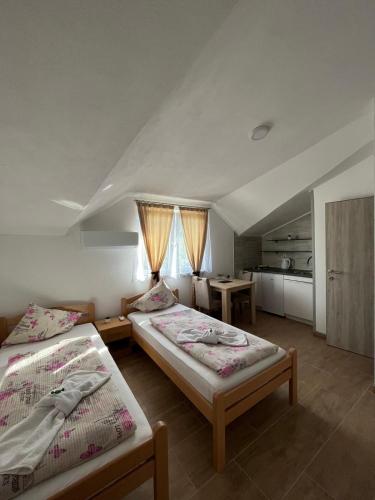 a room with two beds and a kitchen in it at EDINA in Bihać