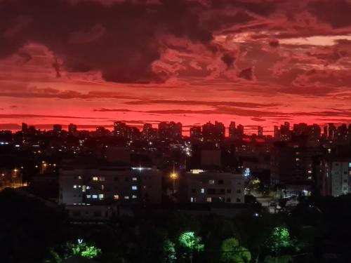 a sunset over a city with a red sky at Hostel AJBJ Turismo in Curitiba