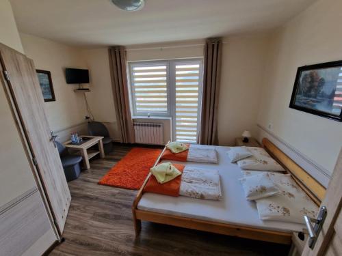a bedroom with two beds and a large window at Irena in Korbielów