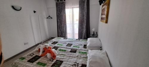 a bedroom with a bed with two dolls on it at Guest House Casa Ramos on the Strip in Albufeira