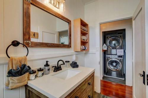 a bathroom with a sink and a washing machine at NEW Paddler's Inn- 3BR Hilo Downtown in Hilo
