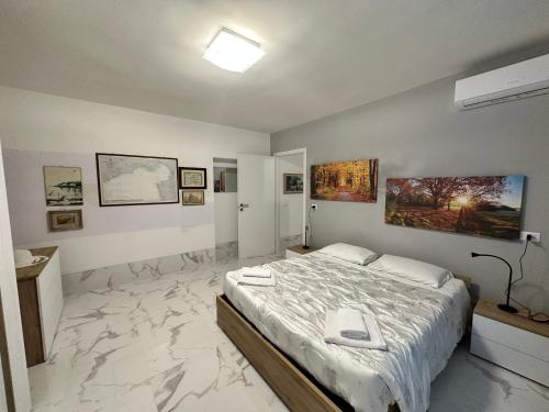 a bedroom with a large bed with a marble floor at Calle de le Pazienze Apartments in Venice