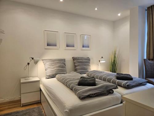 a bed with three pillows on it in a room at Central City White Line in Kiel