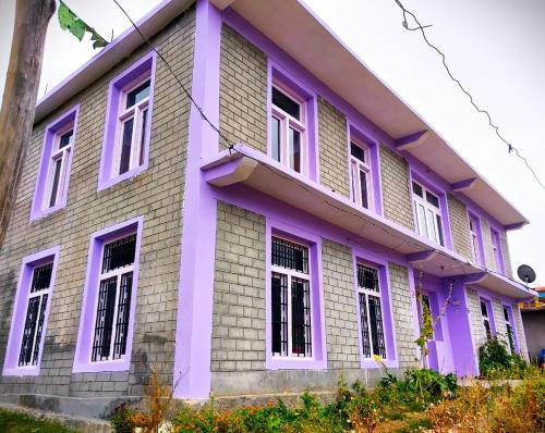 a purple house with white windows at Yangling House in Sissu