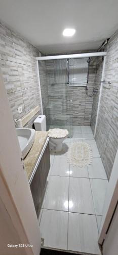 a bathroom with a shower and a toilet and a sink at Hostel AJBJ Turismo in Curitiba
