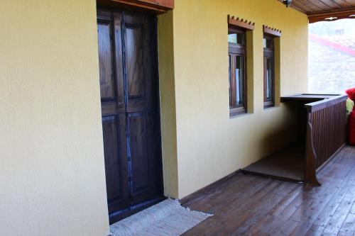 an empty room with a wooden door in a house at Kivotos Epavlis in Prespes