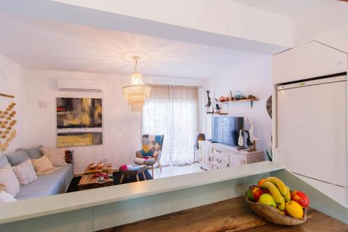 a living room with a couch and a table at Akamas Sunset Boho Chic Maisonette by ONE VILLAS in Polis Chrysochous