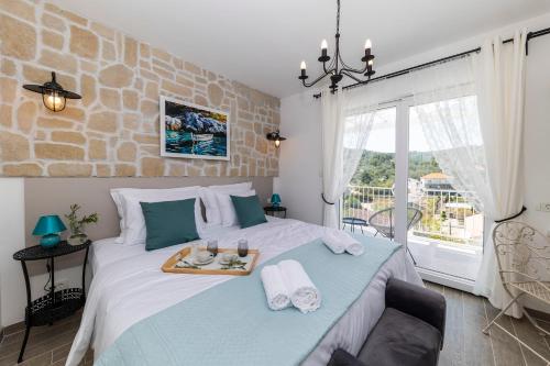 a bedroom with a bed with a tray of food on it at Tilagus holiday villa - Perla in Žman