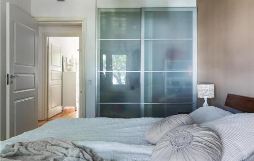 a bedroom with a bed with a large glass wall at 3 Bedroom Stunning Home In Borgholm in Borgholm