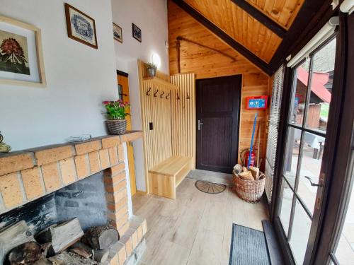 a living room with a fireplace and a door at Holiday Home Marianne in Velké Svatoňovice