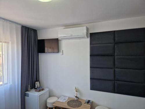 a room with a white refrigerator and a table at ANTIK HOUSE in Cornu de Jos