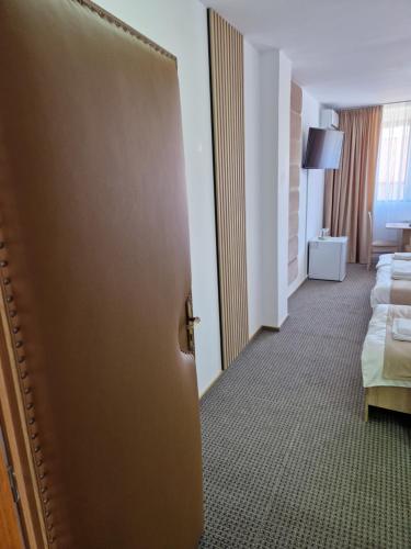 a door to a room with a bed and a living room at ANTIK HOUSE in Cornu de Jos
